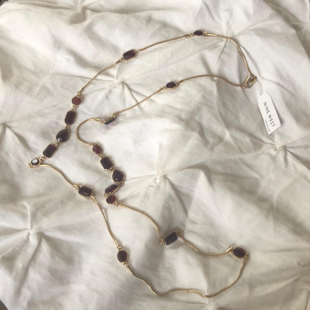 Long Nine West gold necklace with brown/red gems